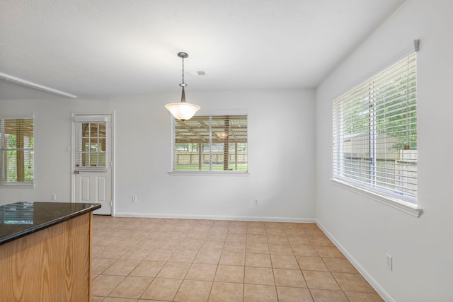 7023 Hayden Dr, Magnolia, TX 77354 - unfurnished dining area with plenty of natural light and light tile patterned floors