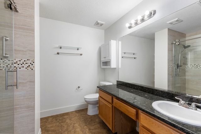 7023 Hayden Dr, Magnolia, TX 77354 - bathroom featuring tiled shower, vanity, and a textured ceiling