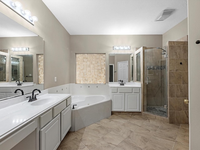247 Private Road 635, Dayton, TX 77535 - bathroom with a shower stall, a bath, and two vanities