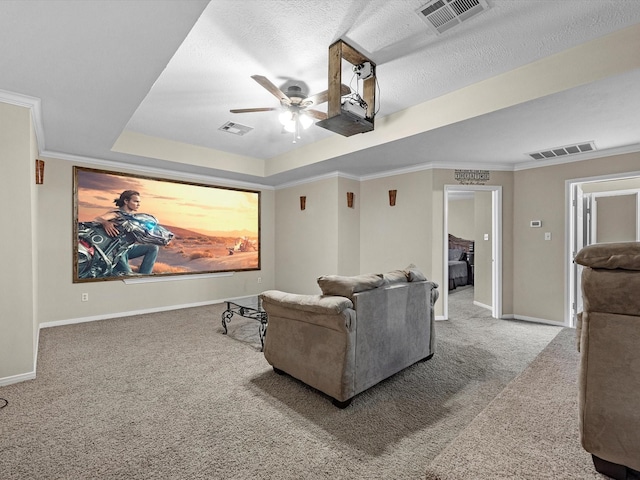 247 Private Road 635, Dayton, TX 77535 - carpeted home theater featuring ceiling fan, a raised ceiling, crown molding, and a textured ceiling