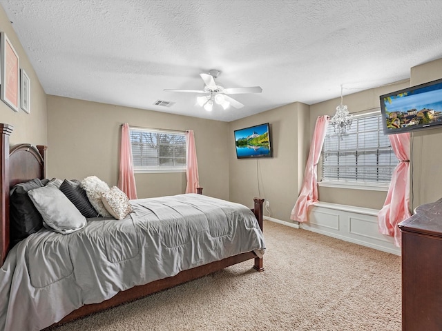 247 Private Road 635, Dayton, TX 77535 - carpeted bedroom featuring a ceiling fan and a textured ceiling