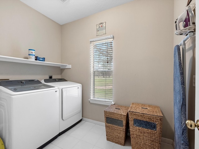 247 Private Road 635, Dayton, TX 77535 - laundry room featuring washer and dryer, healthy amount of natural light, and light tile patterned floors