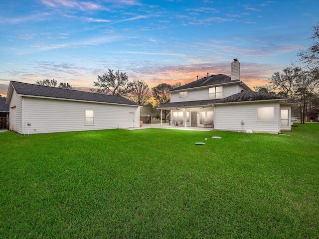 247 Private Road 635, Dayton, TX 77535 - back of house featuring a patio, a lawn, and a chimney