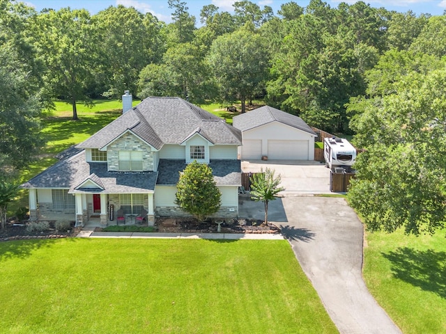 247 Private Road 635, Dayton, TX 77535 - view of front of property featuring roof with shingles, stone siding, a front yard, and a chimney