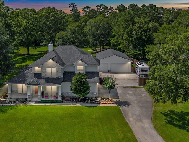 247 Private Road 635, Dayton, TX 77535 - view of front of property featuring stone siding, a porch, a garage, a chimney, and a lawn
