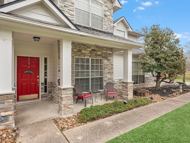 247 Private Road 635, Dayton, TX 77535 - entrance to property with stone siding, covered porch, and a shingled roof