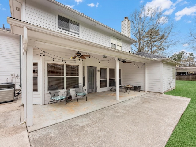 247 Private Road 635, Dayton, TX 77535 - back of property featuring a ceiling fan, a patio area, a chimney, and a lawn