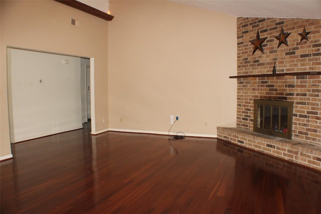 1408 Brandon Ct, Bay City, TX 77414 - unfurnished living room with wood finished floors, a fireplace, and lofted ceiling