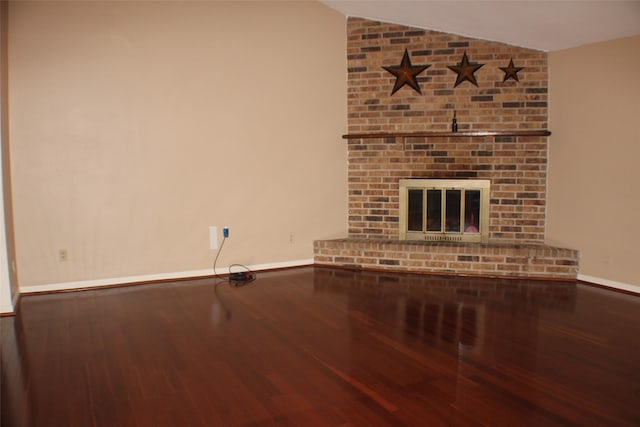 1408 Brandon Ct, Bay City, TX 77414 - unfurnished living room featuring lofted ceiling, wood finished floors, and a fireplace