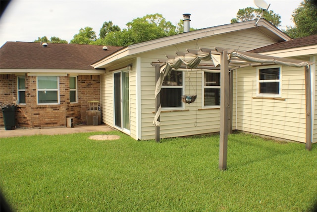 1408 Brandon Ct, Bay City, TX 77414 - back of property with a lawn, brick siding, and roof with shingles