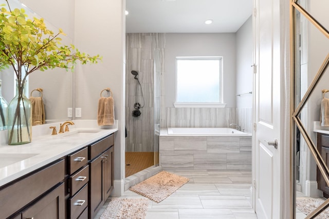 7714 S Fall Run Xing, Houston, TX 77055 - bathroom featuring a garden tub, double vanity, a tile shower, and recessed lighting