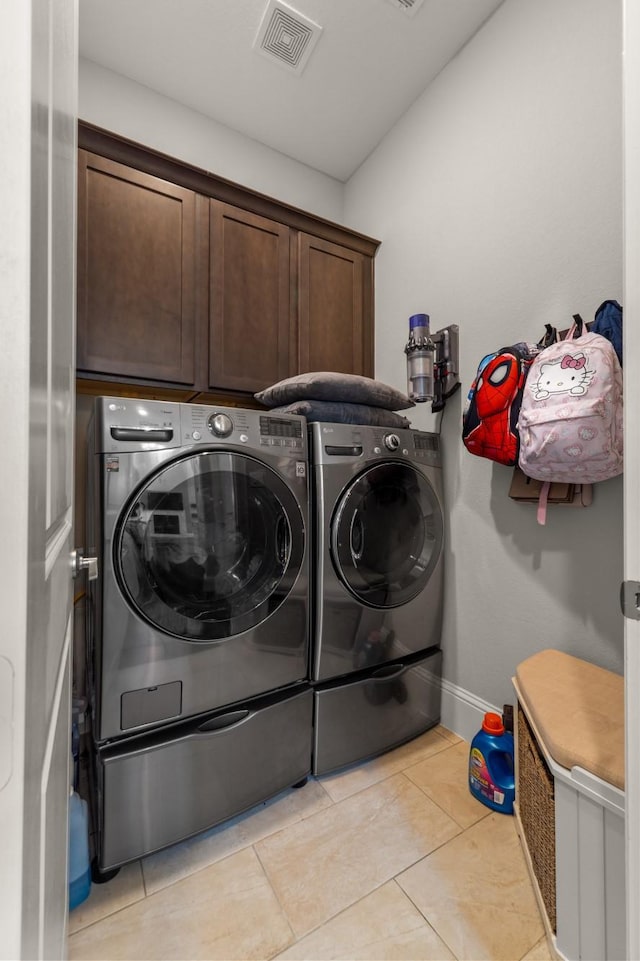 7714 S Fall Run Xing, Houston, TX 77055 - laundry area with cabinet space, washing machine and clothes dryer, and light tile patterned floors