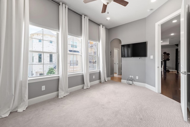 7714 S Fall Run Xing, Houston, TX 77055 - unfurnished bedroom with carpet floors, arched walkways, recessed lighting, and a ceiling fan