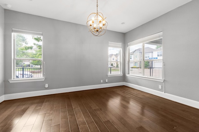 7714 S Fall Run Xing, Houston, TX 77055 - empty room with a chandelier, healthy amount of natural light, and dark wood-style floors
