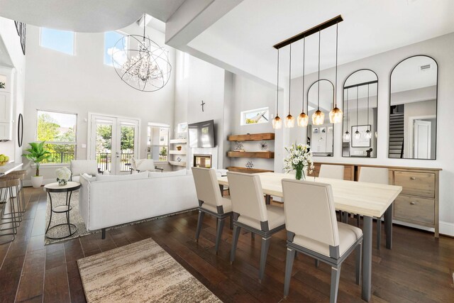 7714 S Fall Run Xing, Houston, TX 77055 - dining space featuring a chandelier, dark wood-style flooring, plenty of natural light, and a high ceiling