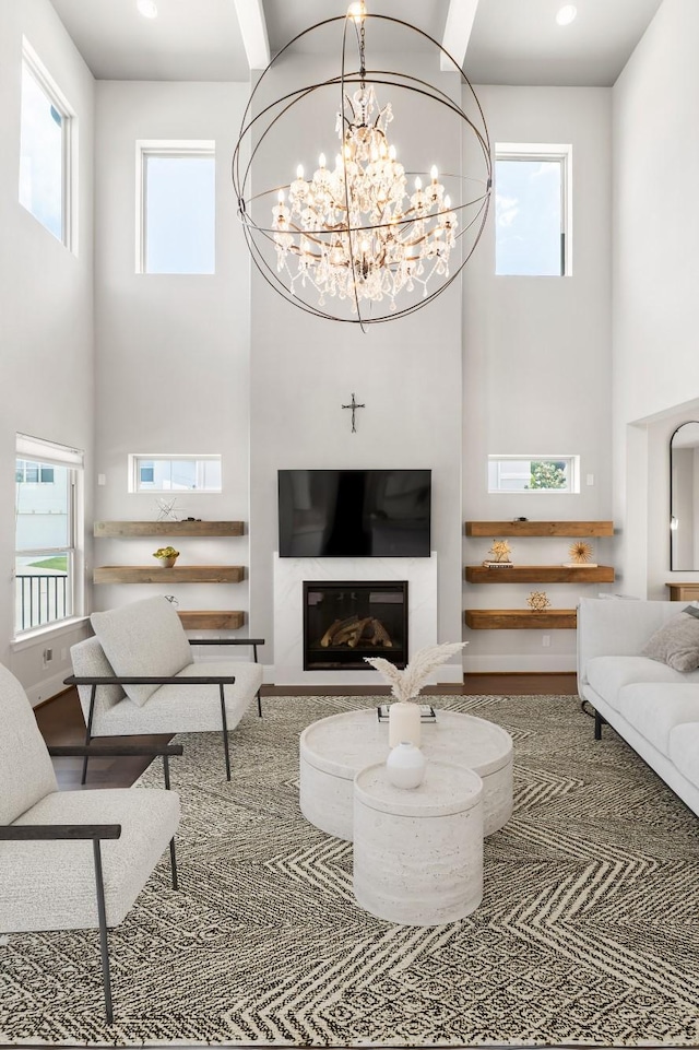 7714 S Fall Run Xing, Houston, TX 77055 - living room with a towering ceiling, a chandelier, and a glass covered fireplace