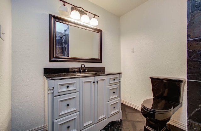 14507 Louetta Rd, Cypress, TX 77429 - bathroom with vanity, a textured wall, and marble finish flooring