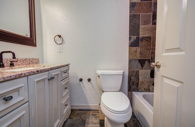 14507 Louetta Rd, Cypress, TX 77429 - bathroom with vanity, stone finish floors, a textured wall, and shower / tub combination