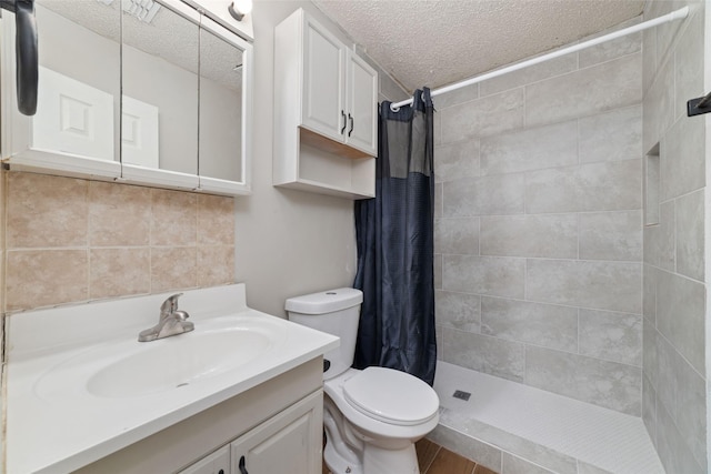 507 S Kansas St, La Porte, TX 77571 - bathroom featuring a textured ceiling, vanity, and a tile shower