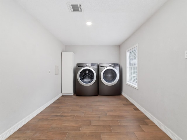 507 S Kansas St, La Porte, TX 77571 - laundry room with washer and clothes dryer and wood finished floors