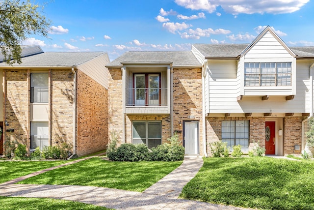 10328 Longmont Dr Unit 47/1, Houston, TX 77042 - view of property with brick siding and a front lawn