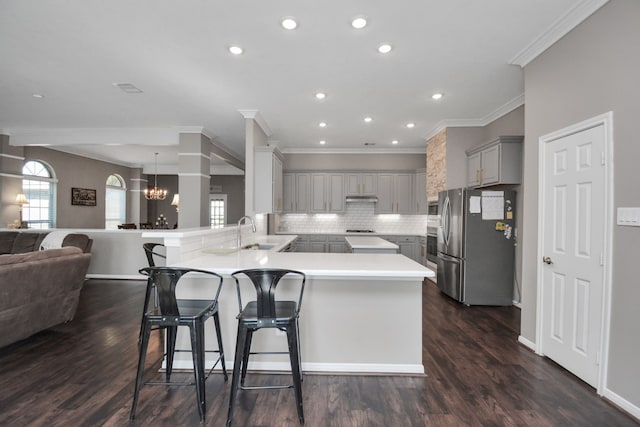 2808 Apache St, League City, TX 77573 - kitchen featuring gray cabinets, freestanding refrigerator, a peninsula, open floor plan, and a chandelier