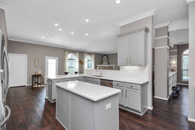 2808 Apache St, League City, TX 77573 - kitchen with a peninsula, stainless steel appliances, gray cabinetry, recessed lighting, and dark wood-style flooring