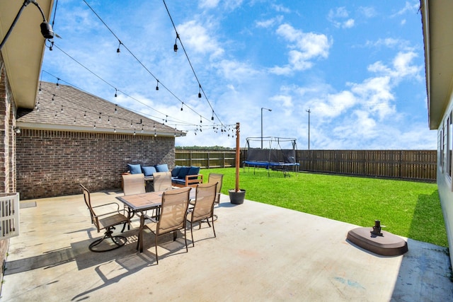 2808 Apache St, League City, TX 77573 - fenced backyard with a trampoline, a patio area, and outdoor dining area