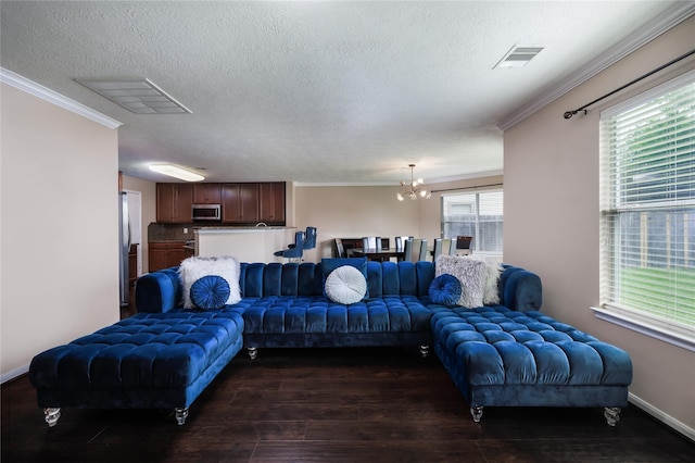 18110 Rexine Ln, Cypress, TX 77433 - living area featuring ornamental molding, a chandelier, dark wood-style flooring, and a textured ceiling
