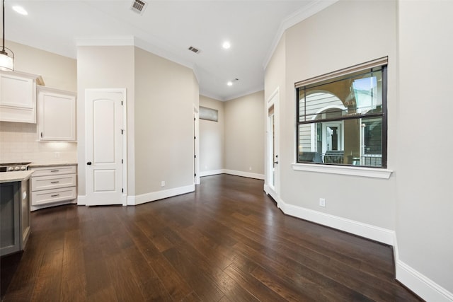 1219 W 25th St Unit D, Houston, TX 77008 - kitchen featuring ornamental molding, white cabinetry, backsplash, dark wood-style flooring, and light stone counters