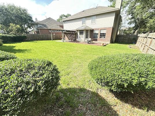 1631 Almond Brook Ln, Houston, TX 77062 - rear view of property with a chimney, a fenced backyard, a patio, and brick siding