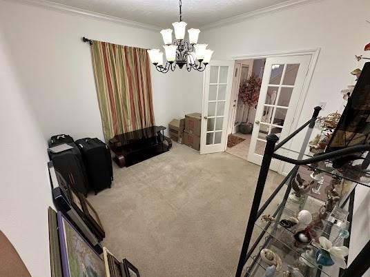 1631 Almond Brook Ln, Houston, TX 77062 - dining space featuring french doors, a chandelier, crown molding, and carpet flooring