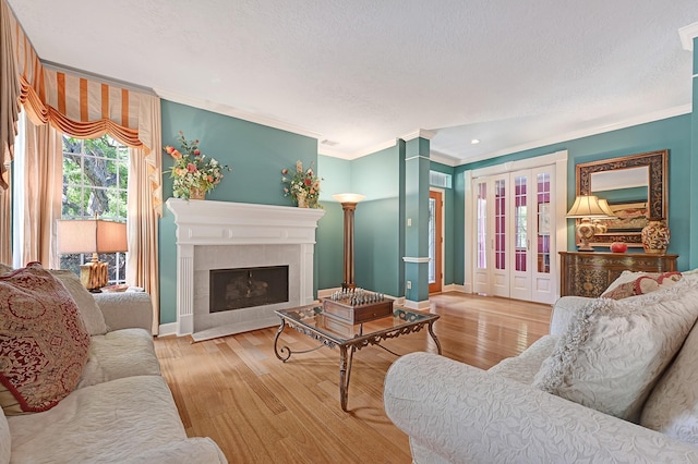 6102 Walkers Park Dr, Sugar Land, TX 77479 - living area with crown molding, wood finished floors, a textured ceiling, a fireplace with flush hearth, and recessed lighting