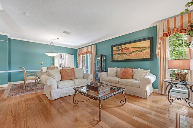 6102 Walkers Park Dr, Sugar Land, TX 77479 - living area featuring healthy amount of natural light, hardwood / wood-style flooring, a textured ceiling, and crown molding