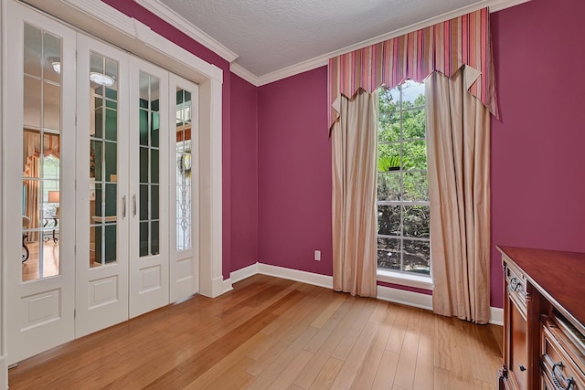 6102 Walkers Park Dr, Sugar Land, TX 77479 - interior space with light wood-type flooring, ornamental molding, a textured ceiling, and french doors