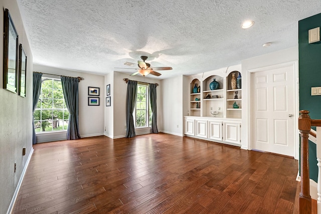 6102 Walkers Park Dr, Sugar Land, TX 77479 - unfurnished living room with plenty of natural light, dark wood-type flooring, ceiling fan, and a textured ceiling