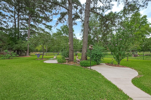 13820 Midway Dr, Willis, TX 77318 - view of home's community with a lawn and view of wooded area