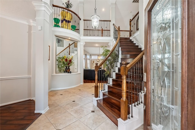 3318 Legends Mist Dr, Spring, TX 77386 - tiled entryway with stairs, decorative columns, a high ceiling, and crown molding
