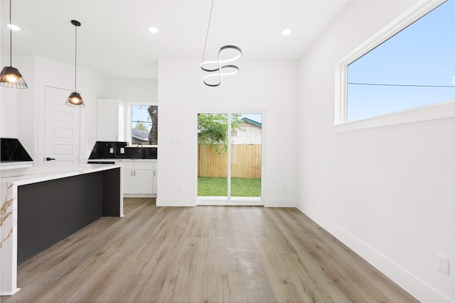 3524 Rebecca St, Houston, TX 77021 - kitchen with white cabinetry, light wood-style floors, pendant lighting, recessed lighting, and tasteful backsplash