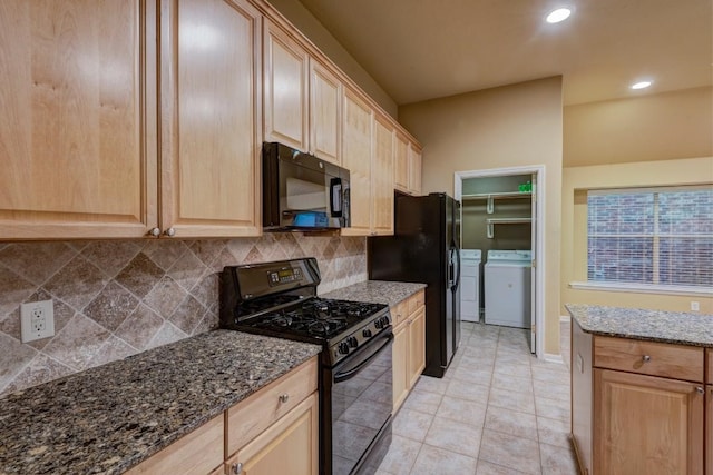 10406 Friars Hill Ln, Houston, TX 77070 - kitchen with black appliances, washer and dryer, light brown cabinets, backsplash, and dark stone counters
