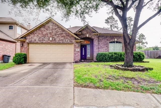 10406 Friars Hill Ln, Houston, TX 77070 - view of front of house featuring an attached garage, brick siding, and concrete driveway