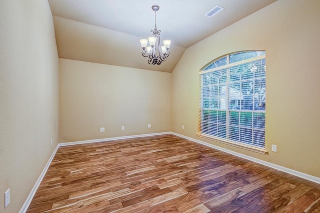 10406 Friars Hill Ln, Houston, TX 77070 - unfurnished room with lofted ceiling, a chandelier, and wood finished floors