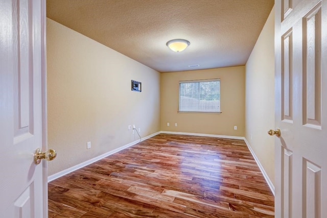 10406 Friars Hill Ln, Houston, TX 77070 - unfurnished room with wood finished floors and a textured ceiling