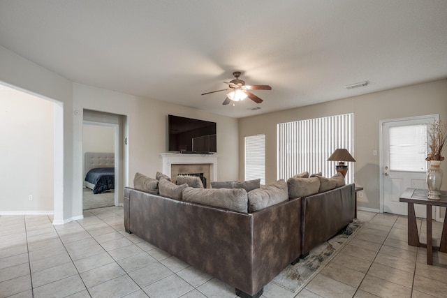 16311 Sylvan Dale Dr, Humble, TX 77346 - living area with a ceiling fan, light tile patterned floors, and a fireplace