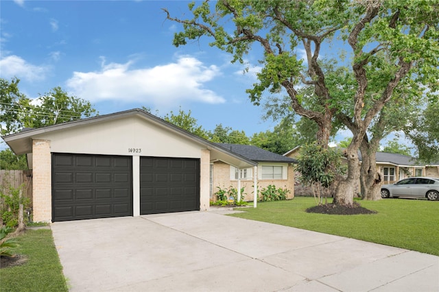 14923 Bathurst Dr, Houston, TX 77053 - single story home featuring a garage, driveway, a front lawn, and brick siding