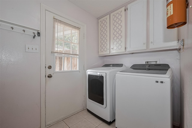15511 Glenwood Park Dr, Houston, TX 77095 - laundry area featuring washer and clothes dryer, cabinet space, and light tile patterned floors