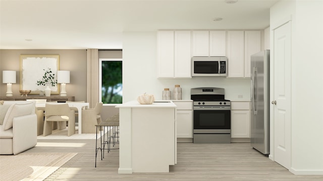 1614 Winwood Dr, Conroe, TX 77303 - kitchen with appliances with stainless steel finishes, light wood-style floors, white cabinets, a breakfast bar, and open floor plan