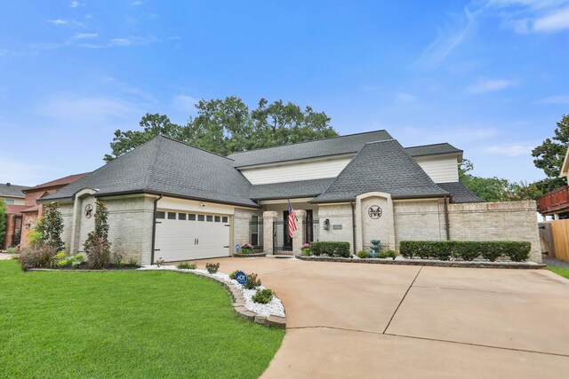 7310 Blenheim Palace Ln, Houston, TX 77095 - french country style house featuring brick siding, roof with shingles, concrete driveway, and an attached garage