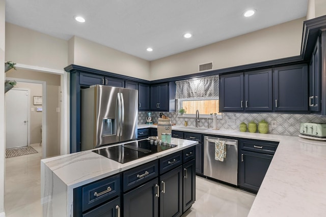 7310 Blenheim Palace Ln, Houston, TX 77095 - kitchen with stainless steel appliances, a kitchen island, tasteful backsplash, light stone countertops, and recessed lighting