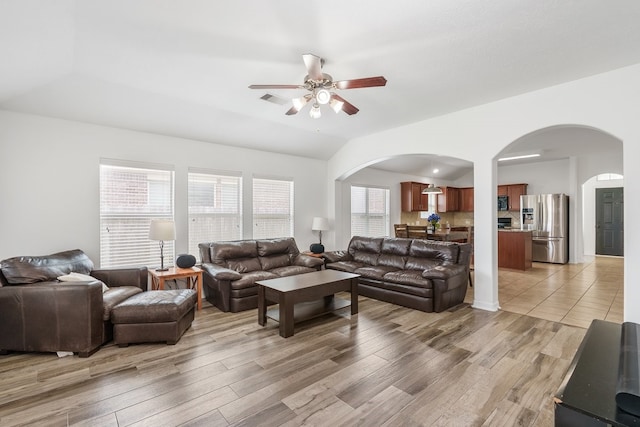 20930 Morgan Knoll Ln, Katy, TX 77449 - living area featuring arched walkways, a ceiling fan, light wood-type flooring, and lofted ceiling